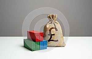 Stack of shipping containers and british pound sterling money bag.