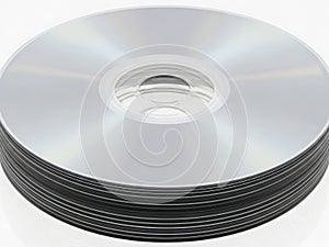 Stack of silver cds against a white background