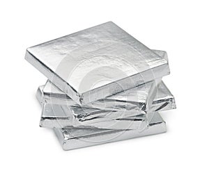 Stack of silver foil wrapped square chocolate bars