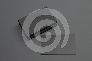 Stack and single black blank textured business cards on dark paper background, us size 3.5 x 2 inches, as template for design