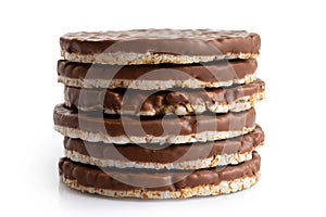 Stack of six chocolate rice cakes isolated on white.