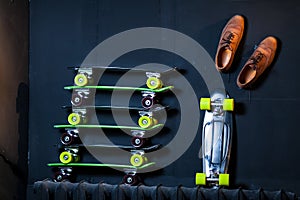 A stack of skateboards is standing against the wall