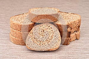 Stack of sliced homemade wholegrain unleavened brown bread on the table