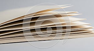 Stack of slightly open beige paper