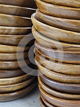 A stack of small wooden bowls or plates, commonly used for serving small snacks or items
