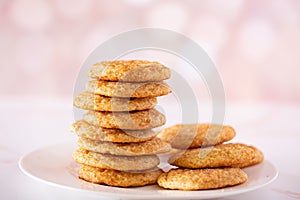 Stack of snickerdoodle cookies on a white plate