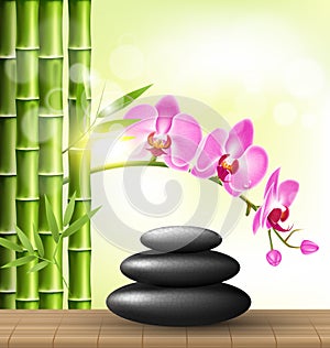 Stack of spa stones with orchid pink flowers and bamboo and sunl