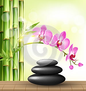 Stack of spa stones with orchid pink flowers and bamboo