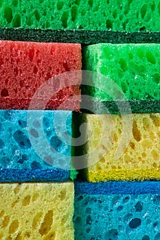 Stack of sponges in red, blue, green, yellow colors ,background