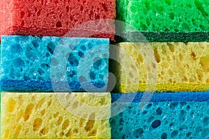 Stack of sponges in red, blue, green, yellow colors ,background