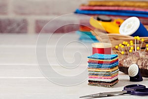 Stack of square pieces of colorful fabrics, accessories for quilting