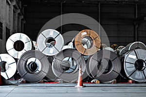 Stack of steel coil in storage warehouse. Steel coils handling equipment. Steel warehouse and logistics operations.