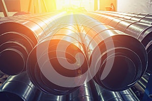 Stack of steel or metal pipes or round tubes as industrial background with perspective