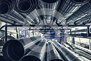 Stack of steel or metal pipes or round tubes as industrial background with perspective