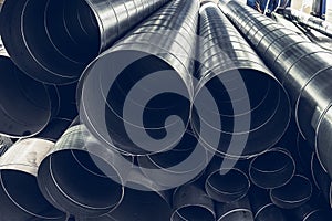 Stack of steel or metal pipes or round tubes as industrial background with perspective