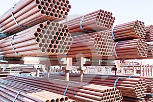 Stack of steel pipes for scaffolding in stock.