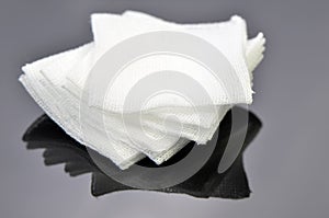 Stack of sterile gauze pad on dark background.