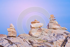 Stack stone on rock against blue sky
