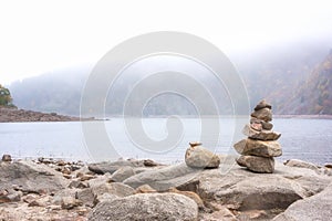 Stack of stones alongside a mountain lake