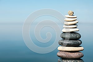 Stack of stones near sea, space for text. Harmony and balance concept