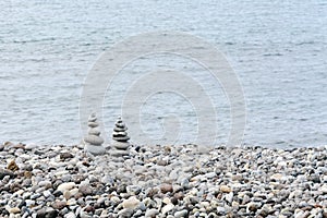 Stack of stones in perfect balance on a tranquil pebble beach.