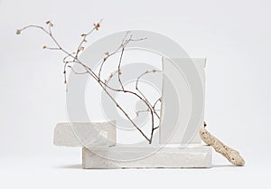 Stack stones platform podium and twig on gray light copy spase background. Minimal empty display product presentation scene photo