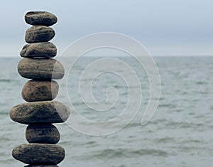 Stack of stones on the shore of a lake