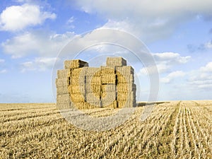 Stack of straw bales in field