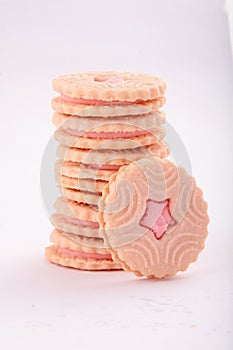 Stack of strawberry cream biscuits.