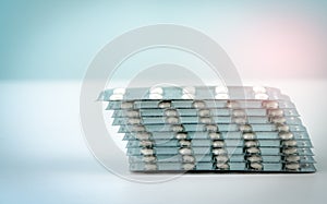 Stack of sugar coated tablet pill on white background. Pharmacy background. Health budgets and policy. Pharmaceutical industry