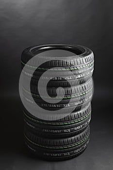 Stack of summer tires, gray background
