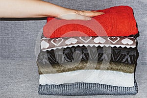 A stack of sweaters, jumpers.