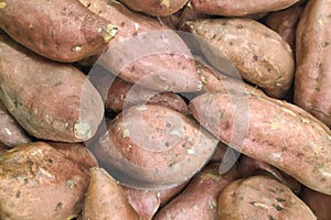 Stack of sweet potatoes on a market stall