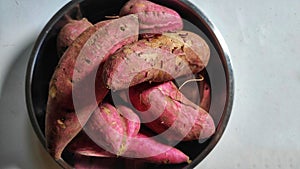 A stack of sweet potatoes in white background