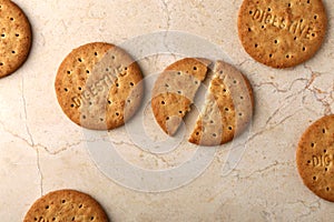 Stack of sweetmeal digestive biscuits closeup of a pile of biscuits on a texture background photo