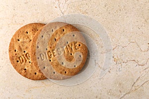 Stack of sweetmeal digestive biscuits closeup of a pile of biscuits on a texture background