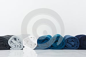 Stack of t-shirt rolled up on white background
