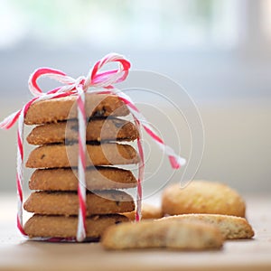 Stack of tasty choc chip cookies on wooden table