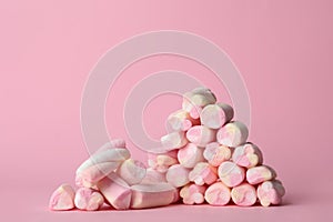 Stack of tasty marshmallows on pink background