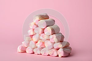 Stack of tasty marshmallows on pink background