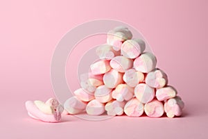 Stack of tasty marshmallows on pink background