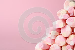 Stack of tasty marshmallows on pink background, closeup. Space for text