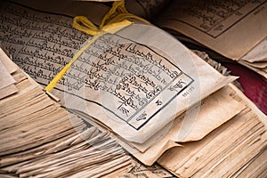 Stack of text verses with Tibetan script at Kumbum Champa Ling Monastery near Xining, China