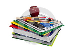 Stack of textbooks with school supplies on top photo