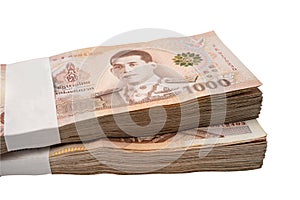 Stack of Thai baht banknotes on white background with clipping path, business saving finance investment concept