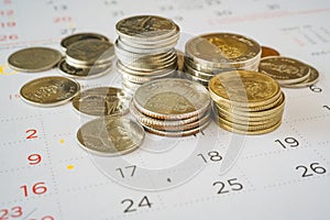 Stack of Thai coins on calendar, closeup shot, for finance background