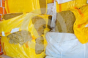 Stack of thermal insulation material is wrapped with cellophane foil