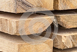 Stack of thick boards new part of warehouse building material background texture