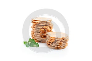 Stack of thin round crispbreads with herbs isolated on white
