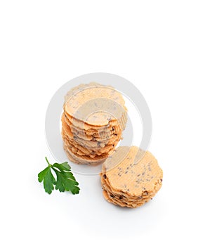 Stack of thin round crispbreads with herbs isolated on white